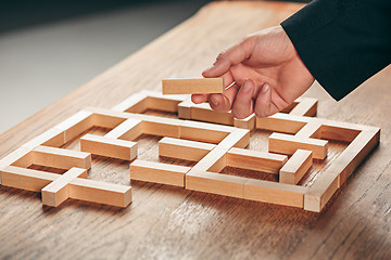 Image showing Man and wooden cubes on table. Management concept