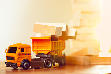 Image showing The toy car and building truck on wooden table