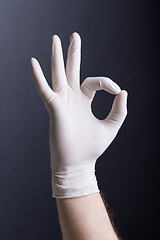 Image showing Male hand in latex glove (OK sign)