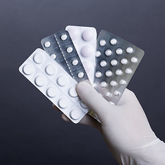 Image showing Hand with pills blisters