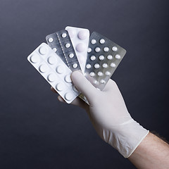 Image showing Hand with pills blisters