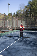 Image showing happy senior athlete  platform tennis paddle court