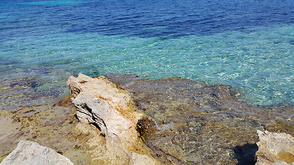 Image showing Bright turquoise sea water and coastal rocks