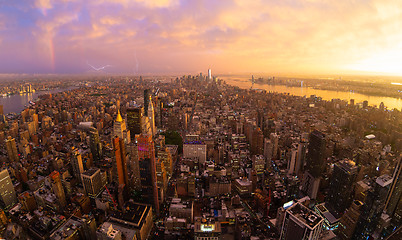 Image showing New York City skyline with Manhattan skyscrapers at dramatic stormy sunset, USA.