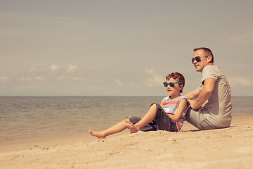 Image showing Father and son  playing on the beach at the day time.