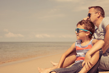 Image showing Father and son  playing on the beach at the day time.