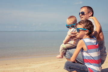 Image showing Father and children  playing on the beach at the day time.