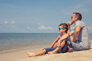 Image showing Father and son  playing on the beach at the day time.