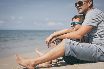 Image showing Father and son  playing on the beach at the day time.