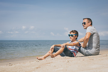 Image showing Father and son  playing on the beach at the day time.