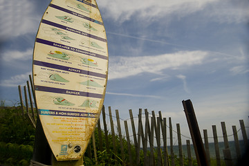 Image showing editorial surfer rules on surf board with Ditch Plains beach bac