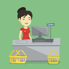 Image showing Cashier standing at the checkout in supermarket.