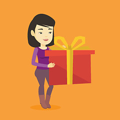 Image showing Joyful asian woman holding box with gift.