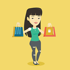 Image showing Happy woman holding shopping bags.