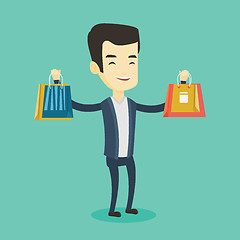 Image showing Happy man holding shopping bags.