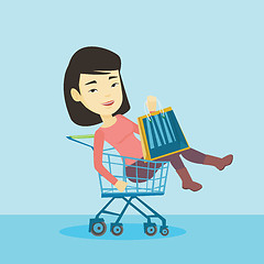 Image showing Happy woman riding by shopping trolley.