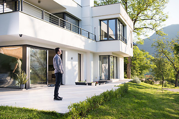 Image showing man in front of his luxury home villa