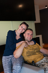 Image showing young handsome couple hugging on the sofa