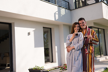 Image showing Young beautiful couple in bathrobes