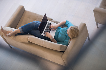 Image showing Young woman using laptop at home