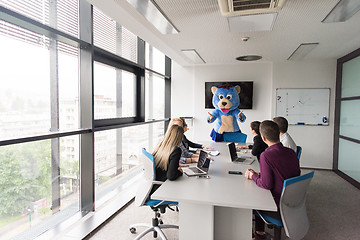 Image showing boss dresed as bear having fun with business people in trendy of