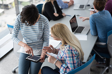 Image showing Pretty Businesswomen Using Tablet In Office Building during conf