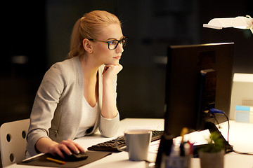 Image showing businesswoman at computer working at night office