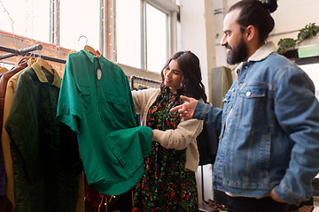 Image showing couple choosing clothes at vintage clothing store