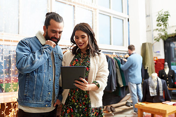 Image showing couple with tablet pc at vintage clothing store