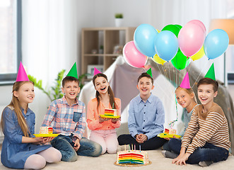Image showing happy children in party hats with birthday cake