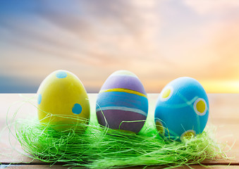 Image showing close up of colored easter eggs and grass