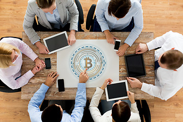 Image showing business team with bitcoin holgram at table