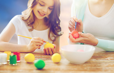 Image showing daughter and mother coloring easter eggs