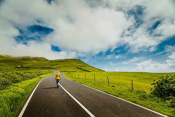 Image showing Woman walking over a beautiful road