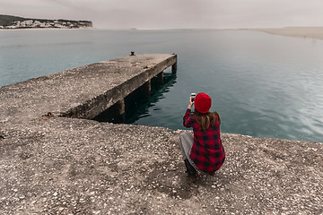 Image showing Woman taking pictures with a cellphone