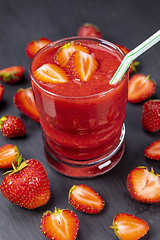 Image showing Strawberry in fresh smoothie on black table