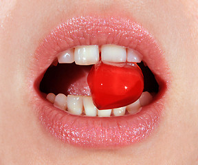 Image showing red lollipop in mouth 