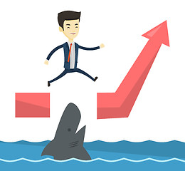 Image showing Business man jumping over ocean with shark.