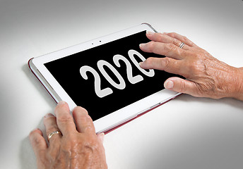 Image showing Senior lady relaxing and her tablet - 2020