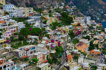 Image showing One of the best resorts of Italy with old colorful villas on the steep slope, nice beach, numerous yachts and boats in harbor and medieval towers along the coast, Positano.