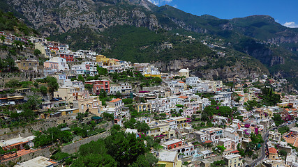 Image showing One of the best resorts of Italy with old colorful villas on the steep slope, nice beach, numerous yachts and boats in harbor and medieval towers along the coast, Positano.