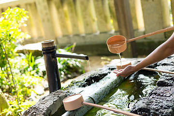 Image showing Woman washing hand before go to Japanese temple