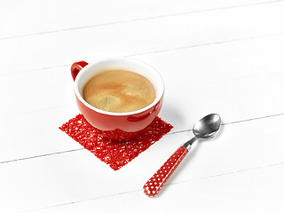 Image showing red coffee cup on wood table