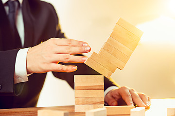 Image showing Man and wooden cubes on table. Management concept