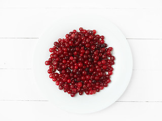 Image showing bowl of cowberries on old wooden table