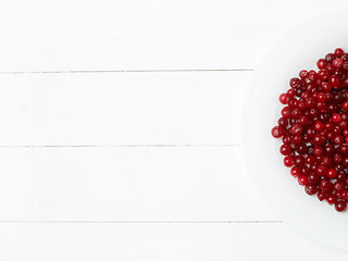 Image showing bowl of cowberries on old wooden table