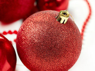 Image showing three red christmas balls isolated on white background