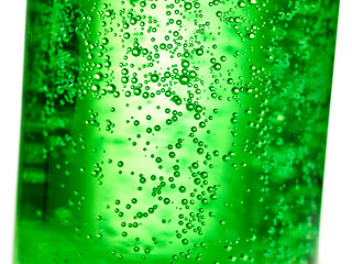 Image showing abstract background : bubble of sparkling water soda on the green glass bottle with gradient light