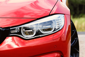 Image showing Red sports car headlight