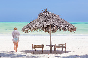 Image showing Lady walking to the sea oat white sandy tropical beach of Paje, Zanzibar, Tanzania.